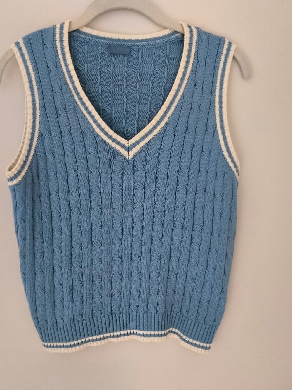 John Galt / Brandy Melville. A light blue cable-knit V-neck sweater vest